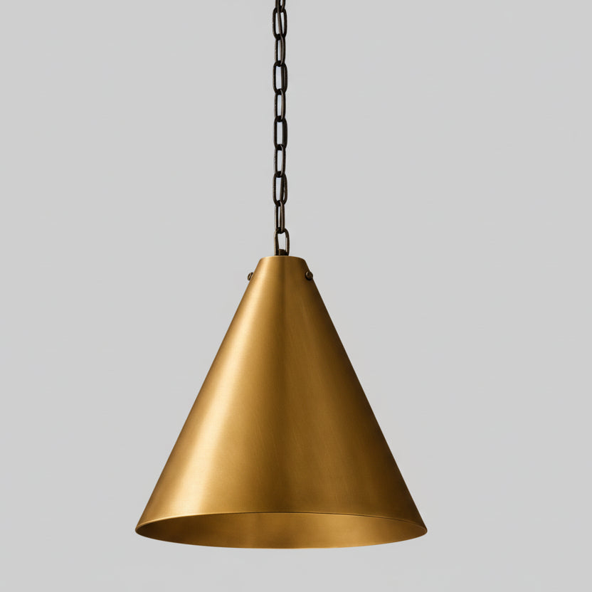 A single, gold-colored pendant light hangs from a chain against a beige background.