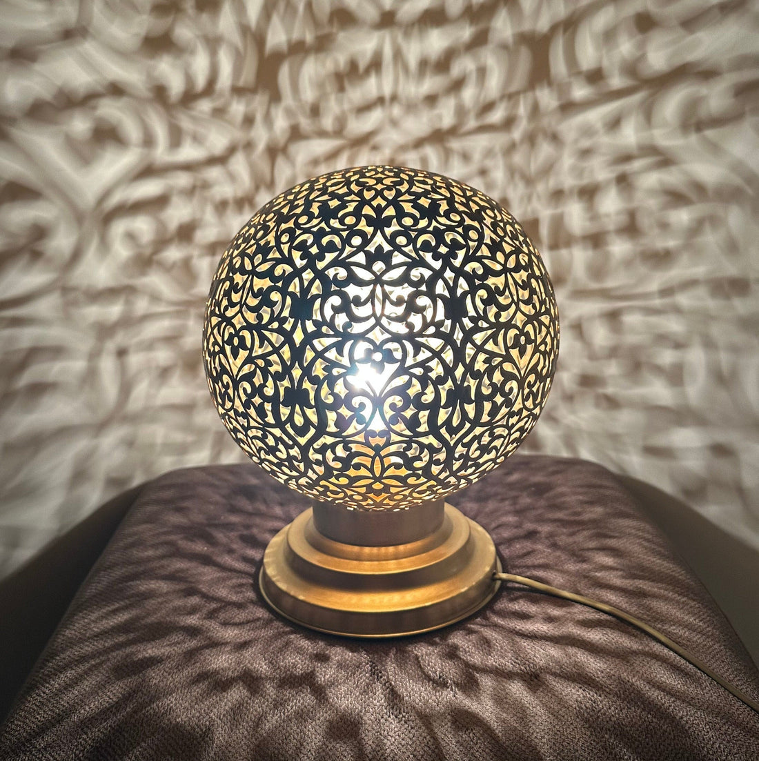 Handcrafted Moroccan brass table lamp with intricate floral cutout design


