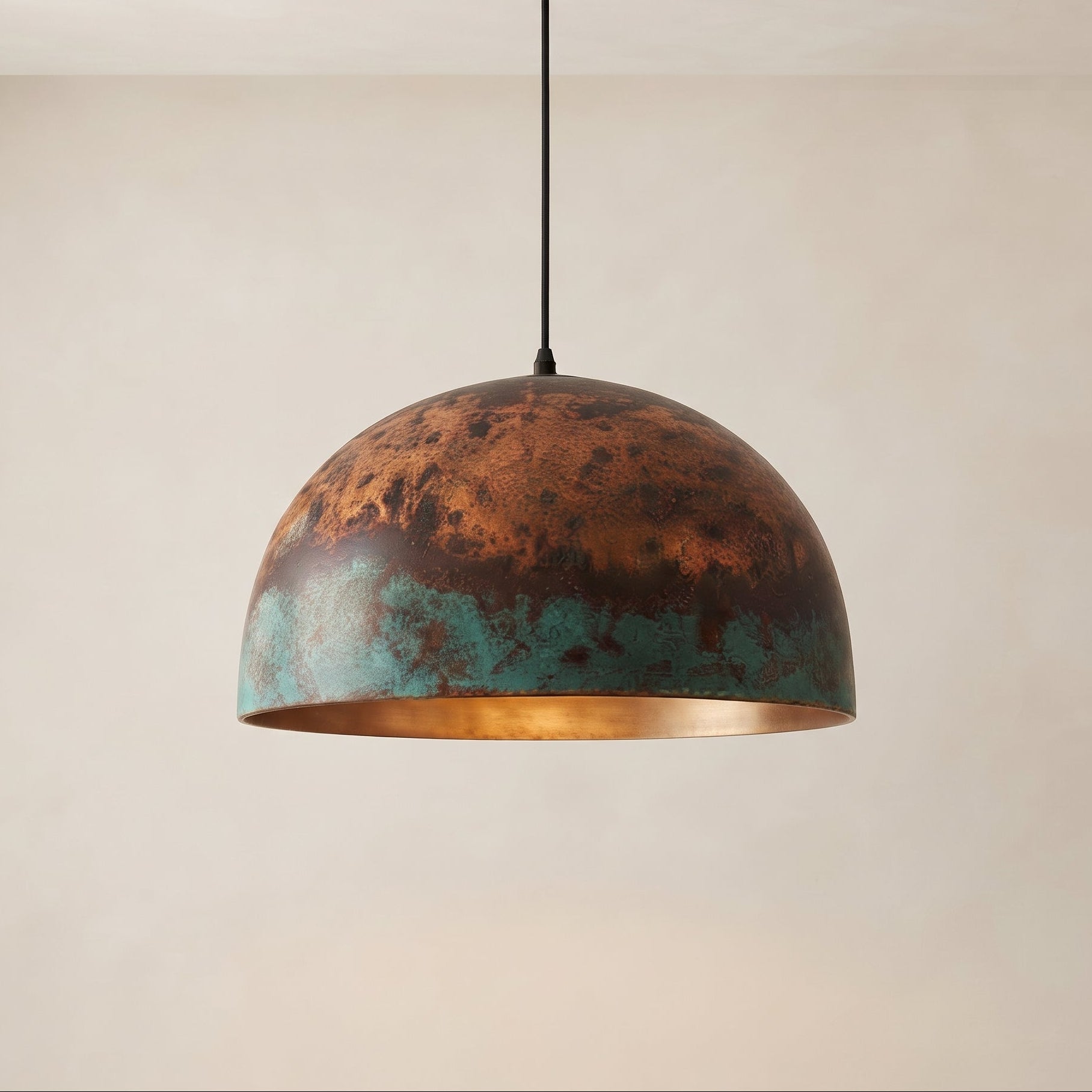 Oxidized copper dome pendant light with green patina and warm copper finish