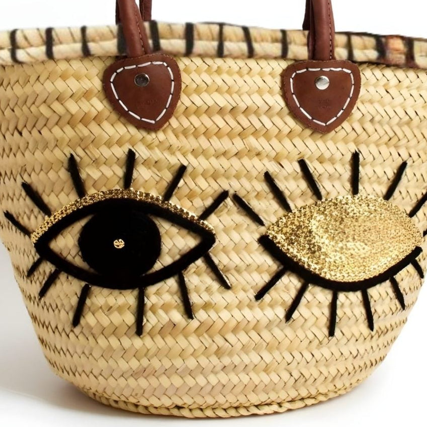 Woven bag with face design on a white background