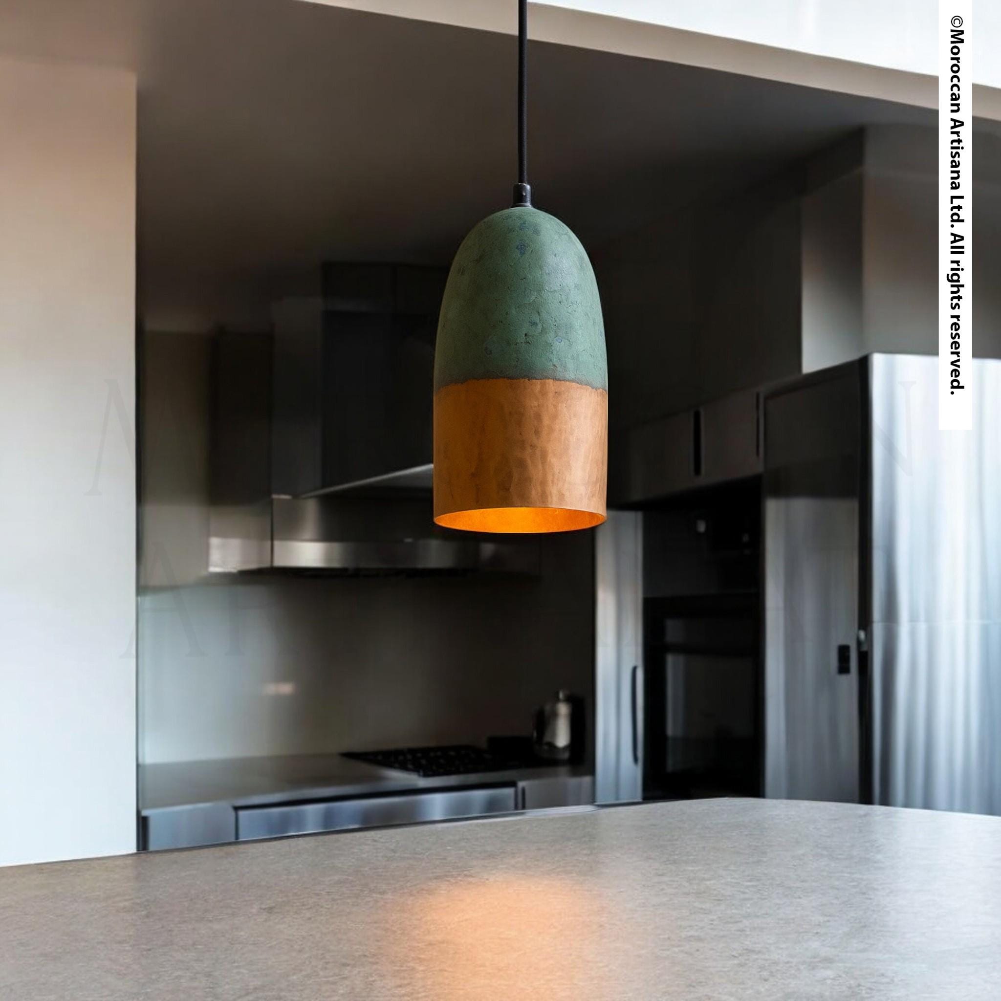 a modern kitchen with a pendant light hanging above a countertop.