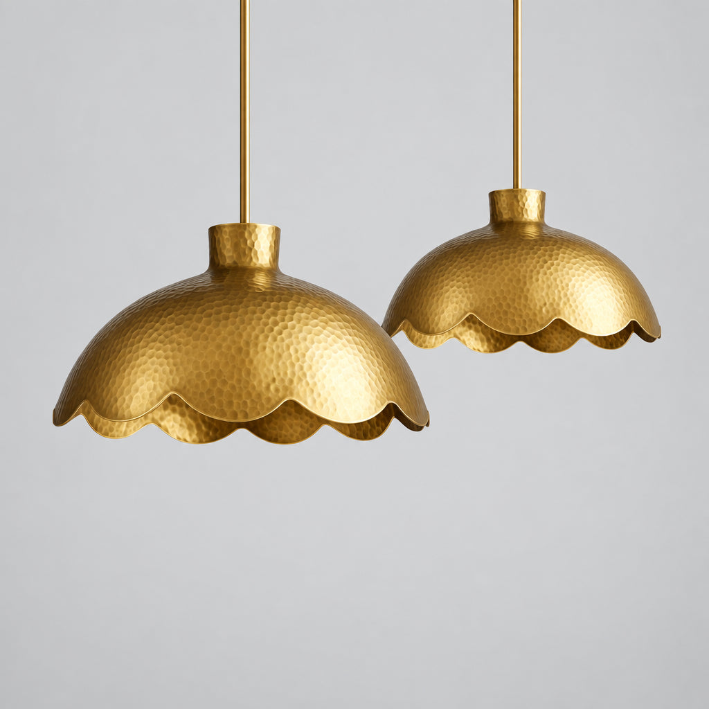 two gold-colored scalloped pendant lights hanging from the ceiling.