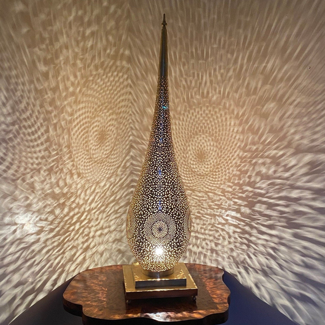 Tall handcrafted Moroccan brass floor lamp with intricate cutout design


