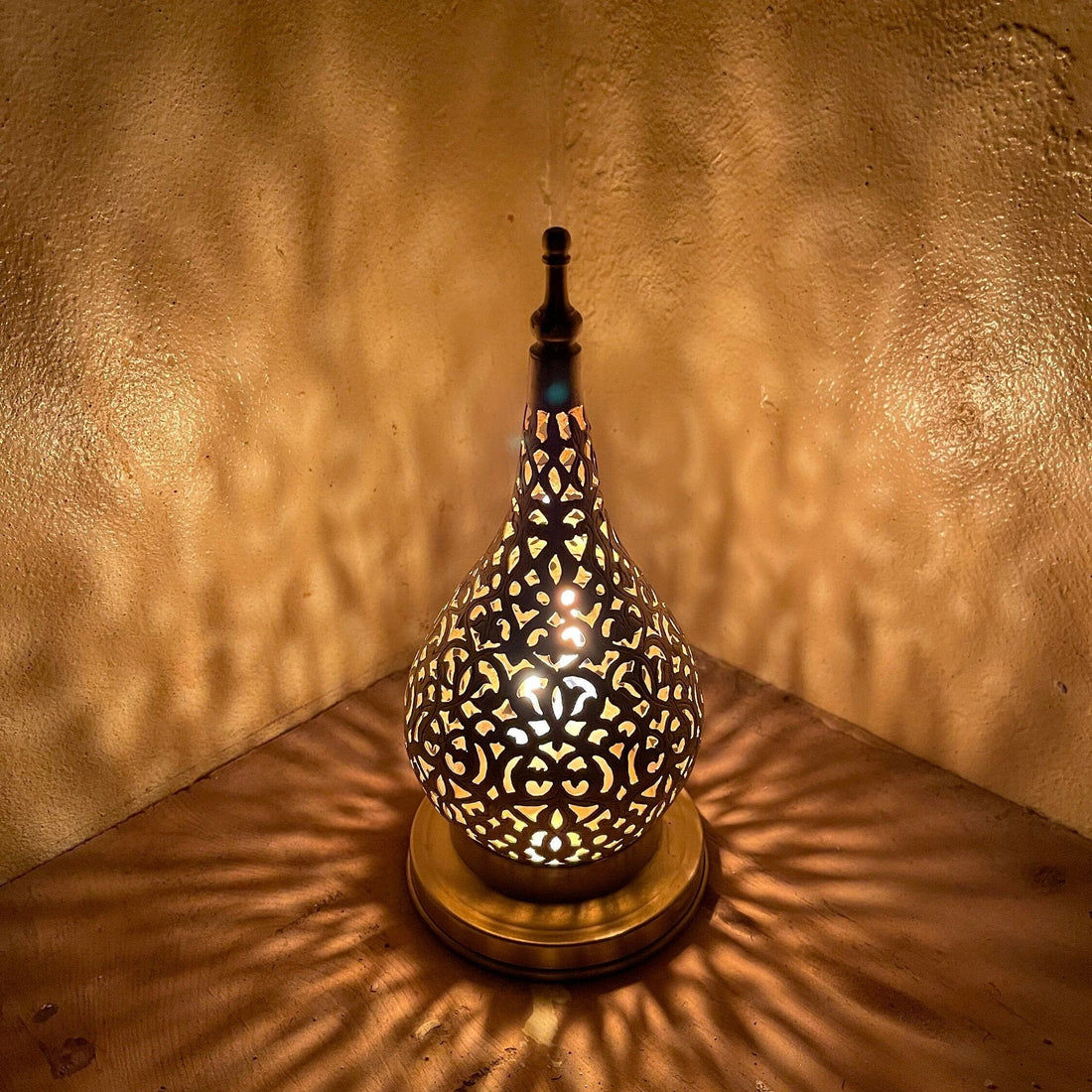 Handcrafted Moroccan brass candle holder with floral cutout design


