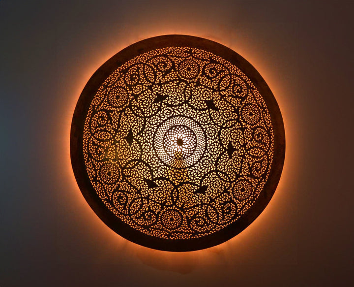 Handmade brass round wall sconce with warm finish for elegant and modern home decor