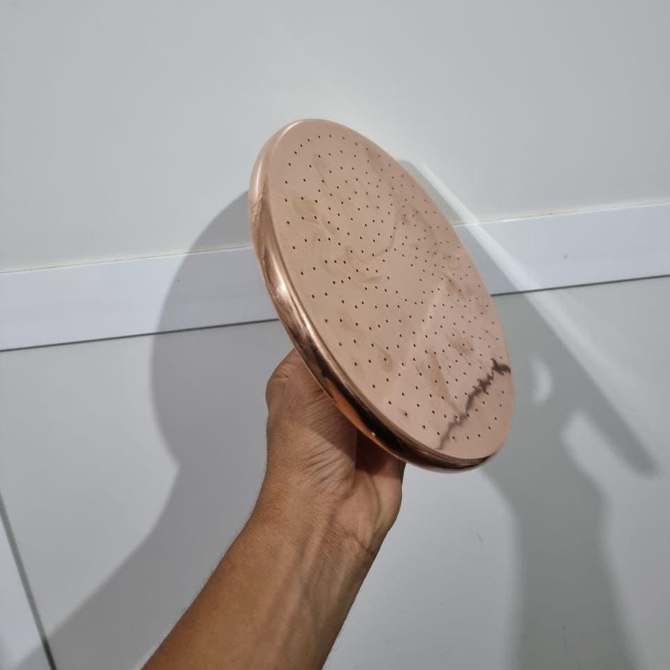 Luxurious copper rainfall shower head with wide spray for a spa-like bathroom upgrade