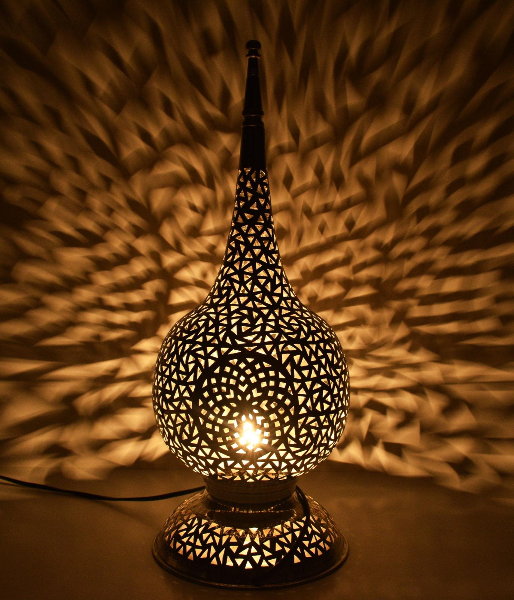 Tall handcrafted Moroccan brass table lamp with geometric cutout design

