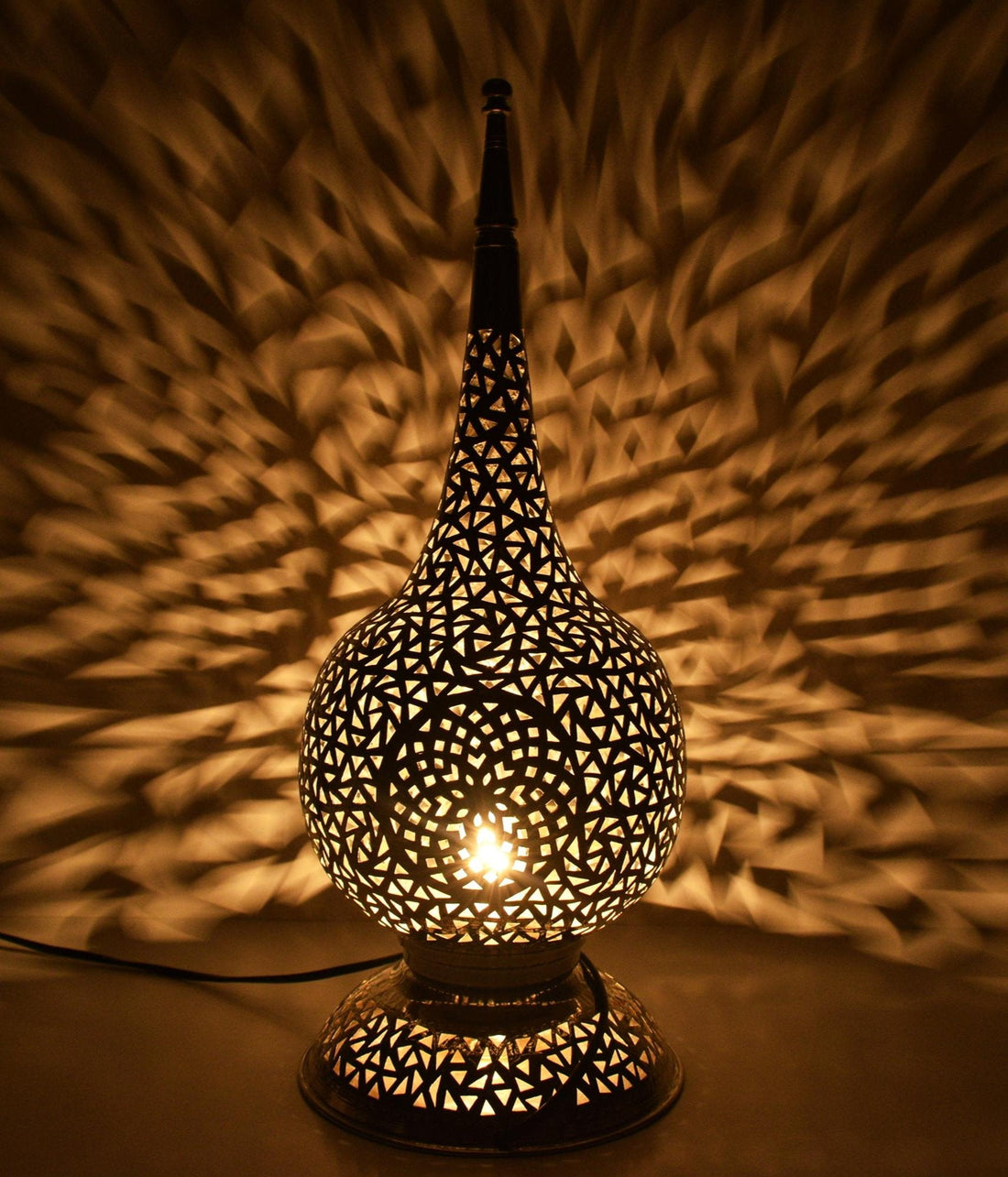 Tall handcrafted Moroccan brass table lamp with geometric cutout design

